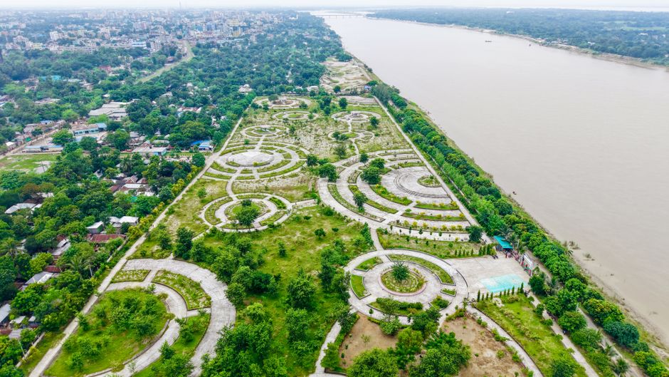 A river running through a green corridor